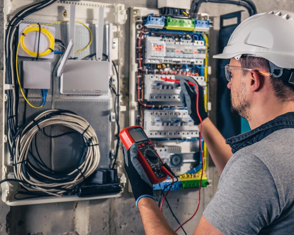 man-electrical-technician-working-switchboard-with-fuses man-electrical-technician-working-switchboard-with-fuses